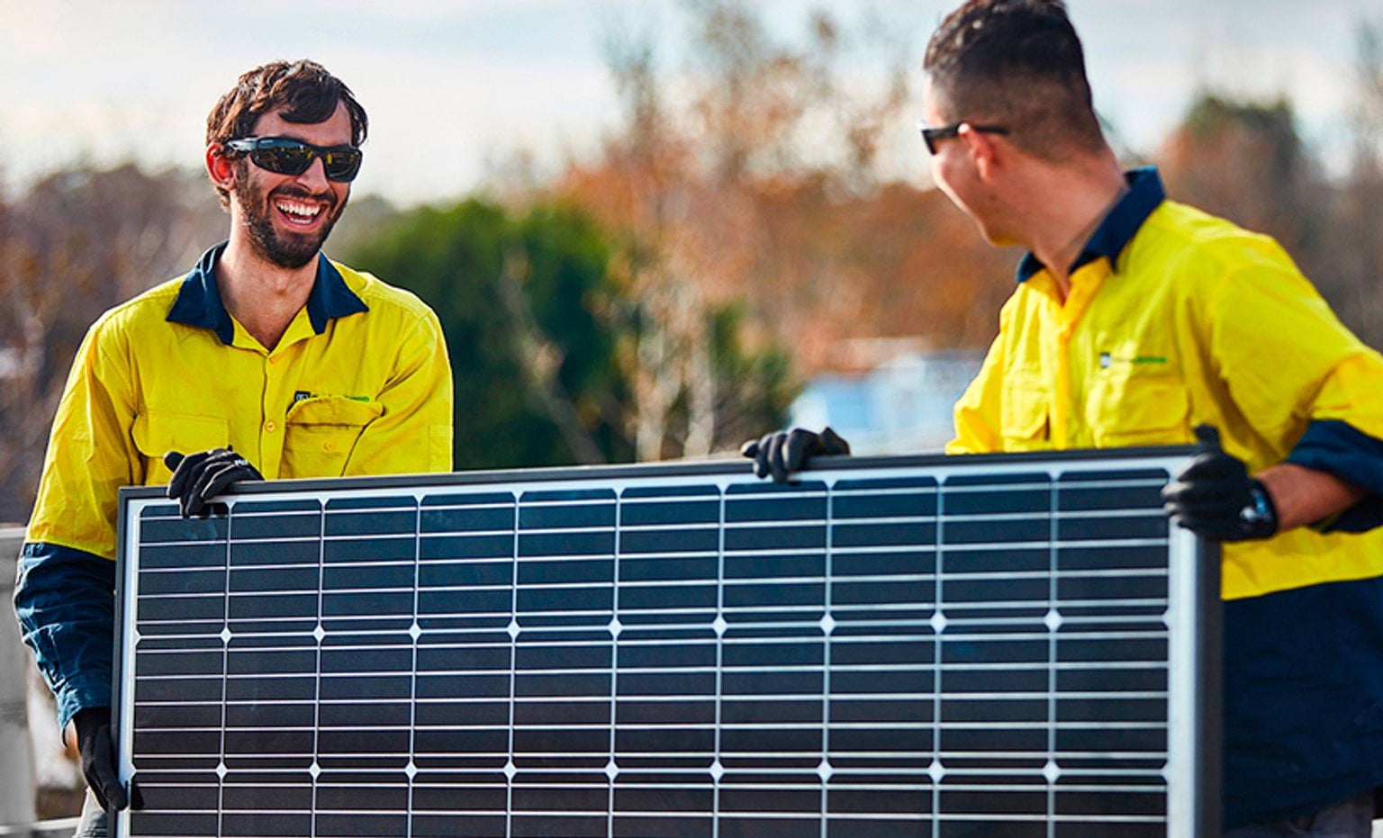 Workers holding a solar panel