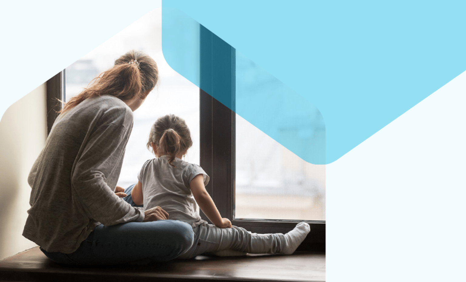 A woman and her child look out the window on a grey day.